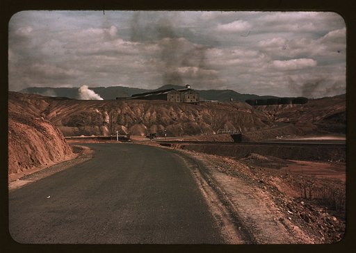 A train bringing copper ore out of the mine, Ducktown, Tenn. Fumes from smelting copper for sulfuric acid have destroyed all vegetation and eroded the land