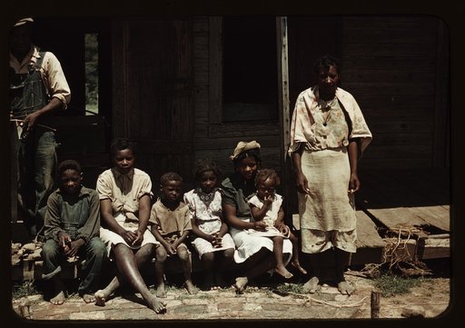 Bayou Bourbeau plantation, a FSA cooperative, Natchitoches, La. A Negro family (?) seated on the porch of a house