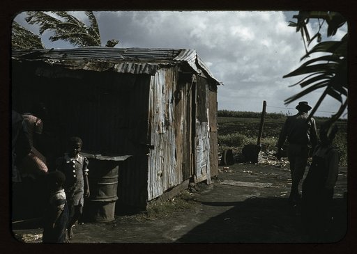 Negro migratory workers by a shack, Belle Glade, Fla.