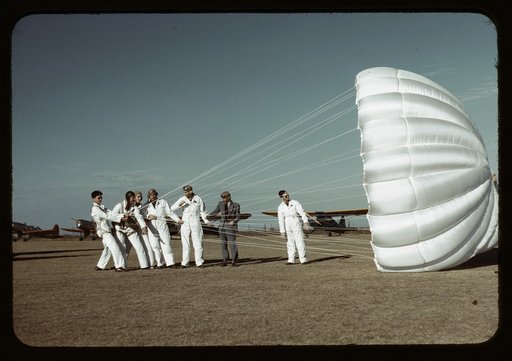 Instructor explaining the operation of a parachute to student pilots, Meacham field, Fort Worth, Tex.