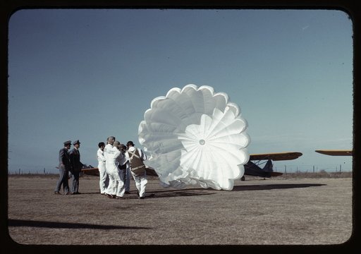 Instructor explaining the operation of a parachute to student pilots, Meacham Field, Fort Worth, Tex.
