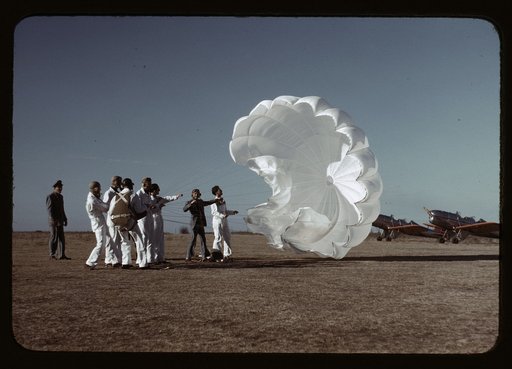 Instructor explaining the operation of a parachute to student pilots, Meacham Field, Fort Worth, Tex.
