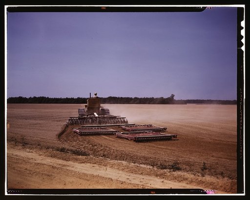 Harrowing a field with a diesel tractor, Seabrook Farm, Bridgeton, N.J.