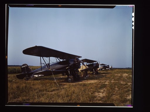 Low flying planes from which dust or insecticide is spread onto crops by men who "follow the season" up the east coast, Seabrook Farm, Bridgeton, N.J.