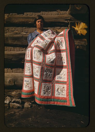 Mrs. Bill Stagg with state quilt which she made, Pie Town, New Mexico