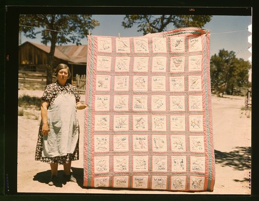 Mrs. Bill Stagg with state quilt that she made, Pie Town, New Mexico. A community settled by about 200 migrant Texas and Oklahoma farmers who filed homestead claims ... Mrs. Stagg helps her husband in the field with plowing planting, weeding corn and harvesting beans. She quilts while she rests duri
