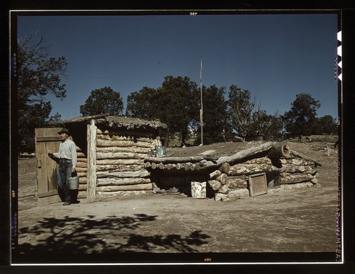 Mr. Leatherman, homesteader, coming out of his dugout home, Pie Town, New Mexico