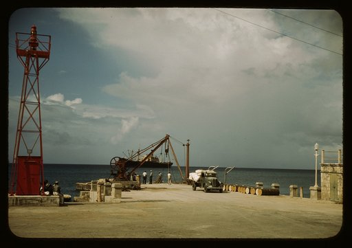 Loading cargo on a freighter in the harbor of Frederiksted, St. Croix, Virgin Islands. Because there is no pier, the ship must anchor far from shore