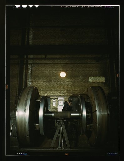 Worn tires on locomotive wheels are refaced on this machine in the wheel shop of the Chicago and Northwestern [i.e. North Western] Railroad, Chicago, Ill.
