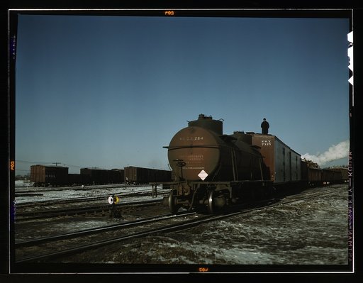 A train (or "cut") being pushed out of a receiving yard toward the hump. A brakeman rides each train to signal the engineer in the locomotive at the rear; Proviso yard, C & NW RR., Chicago, Ill.
