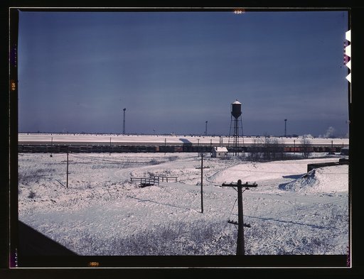 View of a Chicago and Northwestern [i.e. North Western] railroad freight house. A long line of truck trailers are loading and unloading goods, Chicago, Ill.