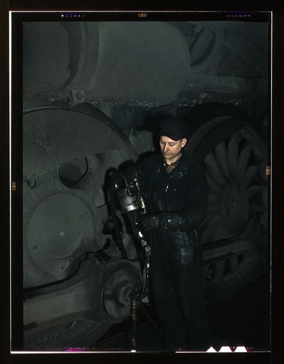 Greasing a locomotive in the roundhouse at Proviso (?) yard, C & NW RR [i.e. Chicago and North Western railroad's], Chicago, Ill.