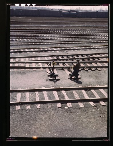 Switchman throwing a switch a C and NW RR's Proviso yard, Chicago, Ill.