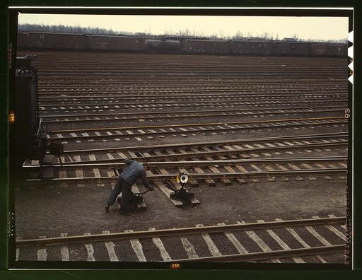 Switchman throwing a switch at C & NW RR's [i.e. Chicago and North Western railroad's] Proviso yard, Chicago, Ill.
