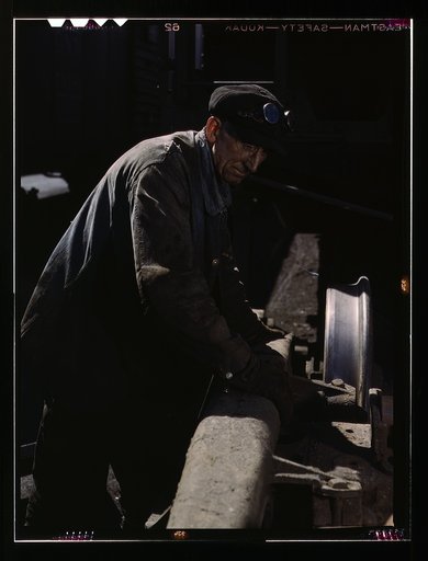 Sam Cell, working on the truck of a car at the rip tracks of C & NW RR's [i.e. Chicago and North Western railroad's] Proviso yard, Chicago, Ill.
