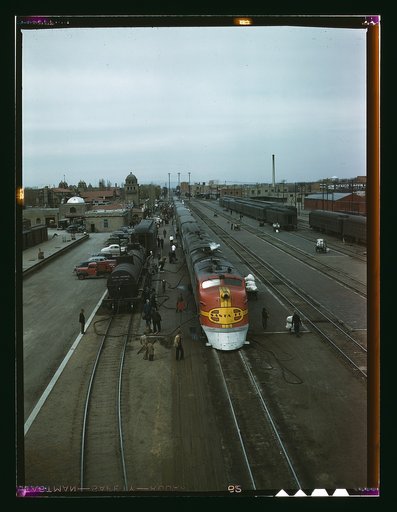 Santa Fe R.R. streamliner, the "super Chief," being serviced at the depot, Albuquerque, N.M. Servicing of these diesel streamliners takes five minutes. Santa Fe R.R. trip