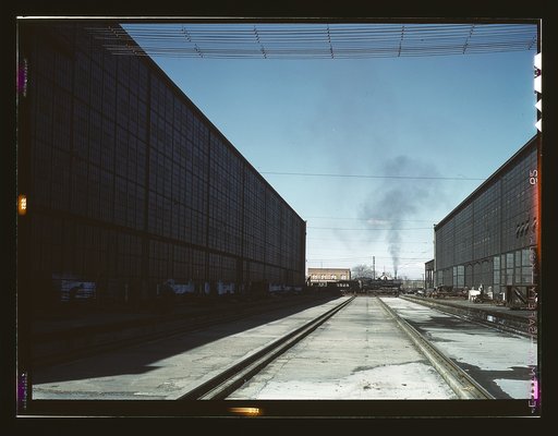 A completely overhauled engine on the transfer table at the Atchison, Topeka, and Santa Fe railroad locomotive shops, Albuquerque, New Mexico. It is now ready to go into service