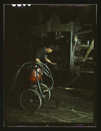 Thomas Madrigal greasing a locomotive in the roundhouse, Rock Island R.R., Blue Island, Ill.