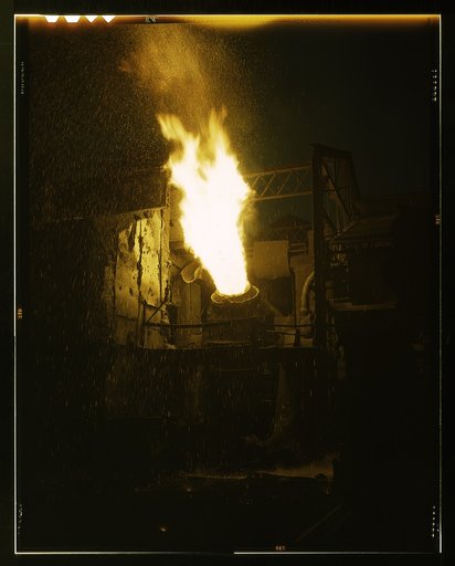 A scene in a steel mill, Republic Steel, Youngstown, Ohio. Molten iron is blown in an Eastern Bessemer converter to change it to steel for war essentials