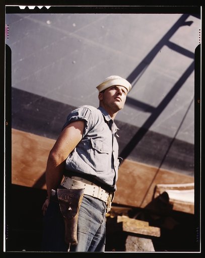 Coast Guardsman standing watch over 78-foot torpedo boat. Continual watch is kept. Higgins Industries, Inc., New Orleans, La.