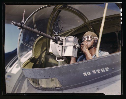 Jesse Rhodes Waller, A.O.M., third class, tries out a 30-calibre machine gun he has just installed on a Navy plane, Naval Air Base, Corpus Christi, Texas