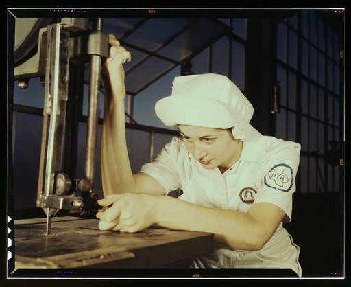 "Women in white" doctor Navy planes (motors) at the Naval Air Base, Corpus Christi, Texas. Mildred Webb, an NYA trainee at the base, is learning to operate a cutting machine in the Assembly and Repair Department. After about eight weeks as an apprentice she will be eligible for a civil service job i