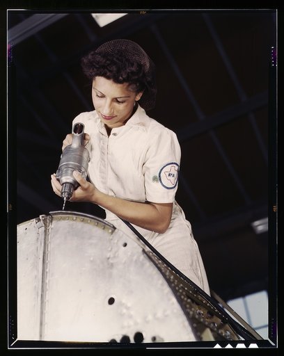 Oyida Peaks riveting as part of her NYA training to become a mechanic in the Assembly and Repair Department at the Naval Air Base, Corpus Christi, Texas