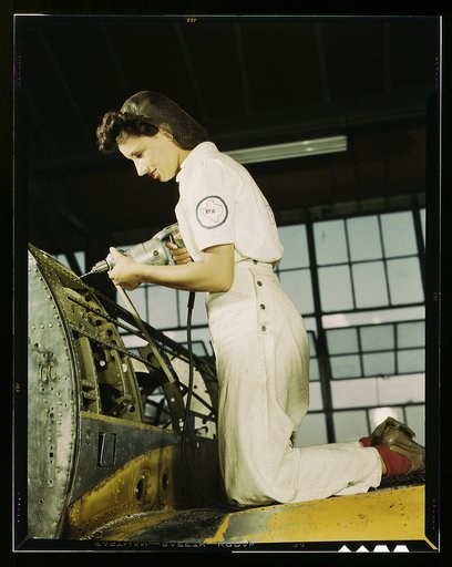Oyida Peaks riveting as part of her NYA training to become a mechanic at the Naval Air Base, in the Assembly and Repair Department, Corpus Christi, Texas