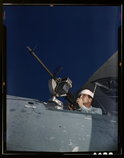 He's like to use that gun on the Axis. After seven years in the Navy, J.D. Estes is considered an old sea salt by his mates at the Naval Air Base, Corpus Christi, Texas