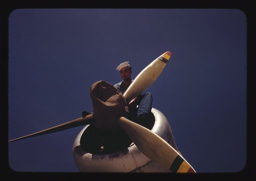 This sailor mechanic is inspecting a PBY plane at the Naval Air Base in Corpus Christi, Texas. The ship had been reconditioned by the Civil Service employees at the Assembly and Repair Department in the base