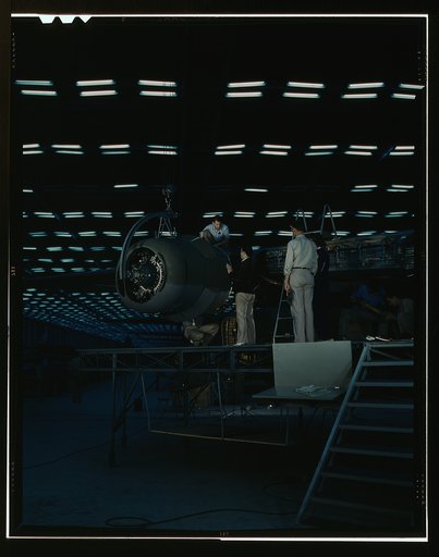 Lowering an engine in place in assembling a transport plane in a Consolidated Aircraft Corporation plant, Fort Worth, Texas