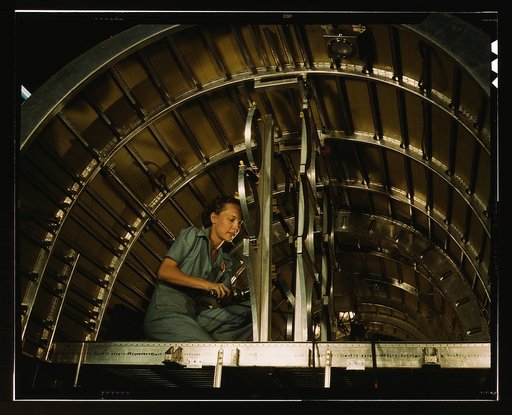 Installing oxygen flask racks above the flight deck of a C-87 transport at the Consolidated Aircraft Corporation plant, Fort Worth, Texas