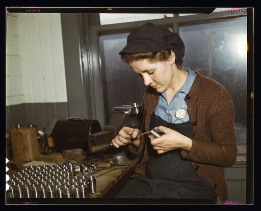 War production workers at the Vilter [Manufacturing] Company making M5 and M7 guns for the U.S. Army, Milwaukee, Wis. Ex-housewife, age 24, filing small parts. Her husband and brother are in the armed service