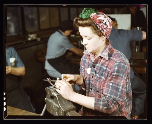 One of the girls of Vilter [Manufacturing] Co. filing small gun parts, Milwaukee, Wisc. One brother in Coast Guard, one going to Army.