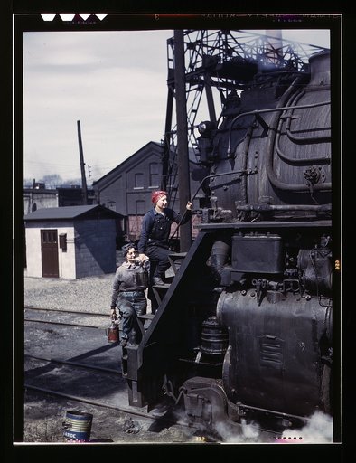 Women wipers of the Chicago and North Western Railroad cleaning one of the giant "H" class locomotives, Clinton, Iowa. Mrs. Marcella Hart and Mrs. Viola Sievers