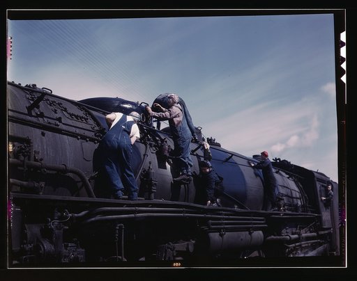 C. & N.W. R.R., women wipers employed at the roundhouse cleaning one of the giant "H" class locomotives, Clinton, Iowa