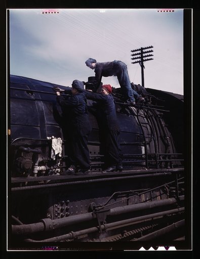 C. & N.W. R.R., women wipers at the roundhouse cleaning one of the giant "H' class locomotives, Clinton, Iowa