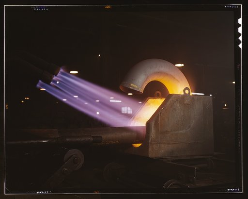 Large pipe elbows for the Army are formed at Tube Turns, Inc., by heating lengths of pipe with gas flames and forcing them around a die, Louisville, Ky.