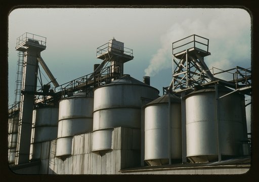 Section of the batch house at a plant of the Owens-Corning Fiberglass Corporation, Toledo, Ohio. In the bins are stored the raw materials for the batch from which fiberglass materials vital to the war effort are produced