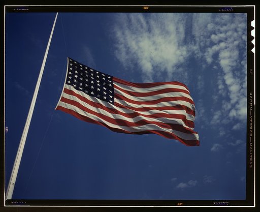 High above, over a true "home of the brave," the floating folds of the Star Spangled Banner symbolize the American way of life to soldiers in training for the battles that will bring freedom to an unhappy, wartorn world, Fort Knox, Ky.