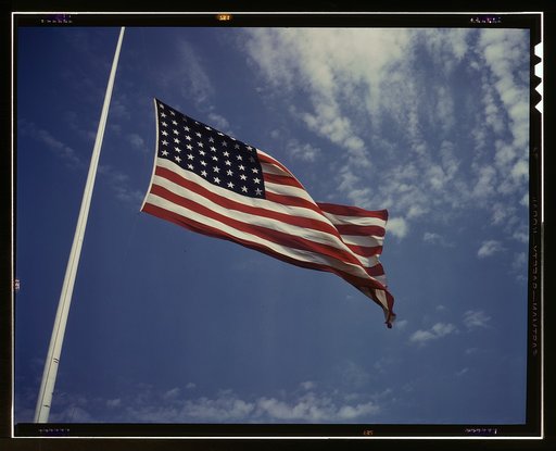 High above, over a true "home of the brave," the floating folds of the Star Spangled Banner symbolize the American way of life to soldiers in training for the battles that will bring freedom to an unhappy, war-torn world, Fort Knox, Ky.