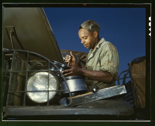 A good job in the air cleaner of an army truck, Fort Knox, Ky. This Negro soldier, who serves as truckdriver and mechanic, plays an important part in keeping army transport fleets in operation