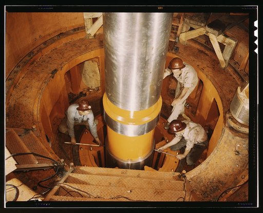 Checking the alignment of a turbine shaft at the top of the guide bearing in TVA's hydroelectric plant, Watts Bar Dam, Tenn. Located 530 miles above the mouth of the Tennessee River, the dam has an authorized power installation of 90,000 kw., which can be increased to a possible ultimate of 150,000 