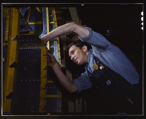 A wing brace assembly for a B-25 bomber is prepared for the assembly line of an aircraft plant, North American Aviation, Inc., Calif. With plenty of speed, a 1,700-mile cruising range and a ceiling of 25,000 feet, it has performed as a medium bomber and as an escort plane