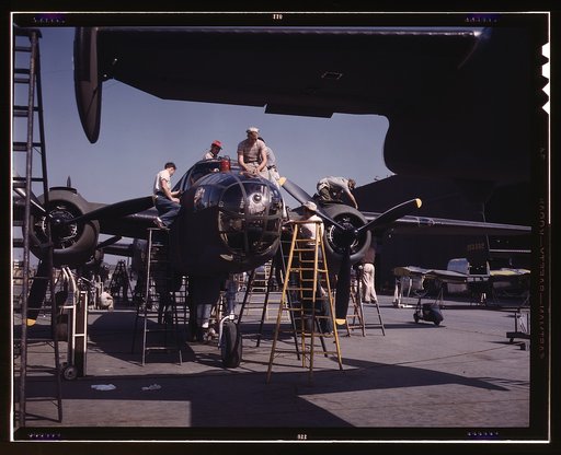 Employees on the "Sunshine" assembly line at North American's plant put the finishing touches on another B-25 bomber, Inglewood, Calif. In addition to the battle-tested B-25 ("Billy Mitchell") bomber, used in General Doolittle's raid on Tokyo, this plant produces the P-51 ("Mustang") fighter plane w