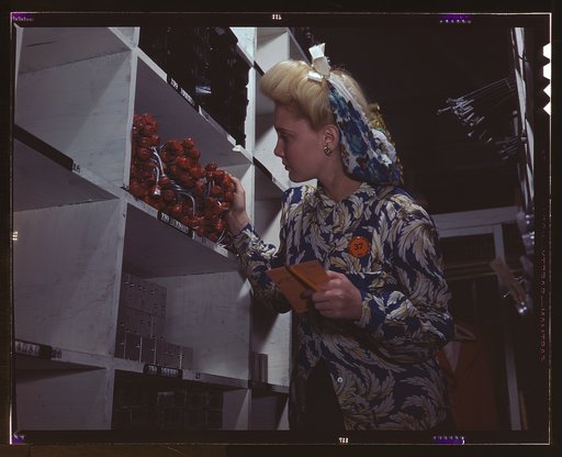 Clerk in one of the stock rooms of North American Aviation, Inc., checking to see if the proper numbers of parts were received and placed in the proper bin, Inglewood, Calif. This plant produces the battle-tested B-25 ("Billy Mitchell") bomber, used in General Doolittle's raid on Tokyo, and the P-51