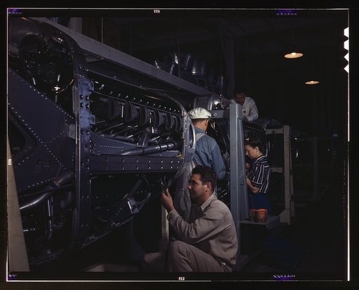 Employees at North American Aviation, Incorporated, assembling the cowling on Allison motors for the P-51 fighter planes, Inglewood, Calif.