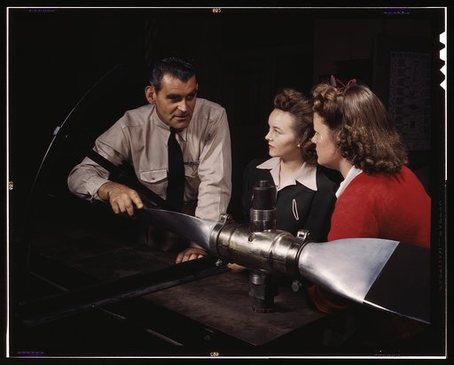 Students at Washington High School at class, training for specific contributions to the war effort, Los Angeles, Calif. Ralph Angar, instructor, explains propeller characteristics to student[s] in the aeronautics class