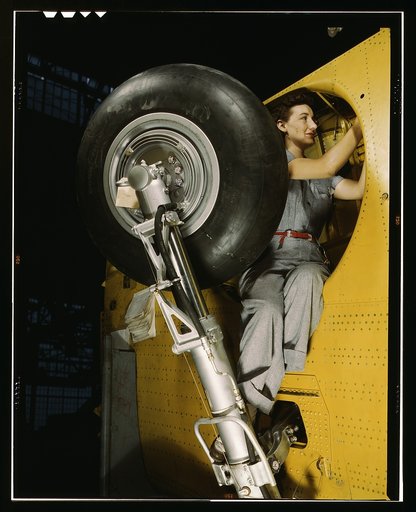 This woman worker at the Vultee-Nashville is shown making final adjustments in the wheel well of an inner wing before the installation of the landing gear, Nashville, Tenn. This [is] one of the numerous assembly operations in connection with the mass production of Vultee "Vengeance" dive bombers
