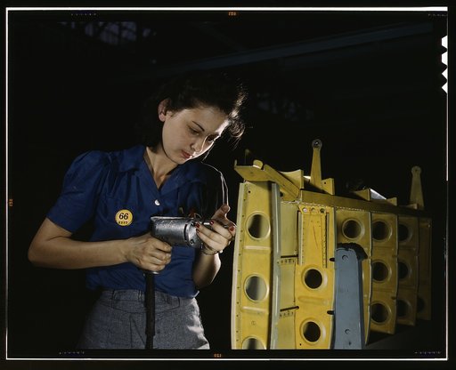 Drilling horizontal stabilizers: operating a hand drill, this woman worker at Vultee-Nashville is shown working on the horizontal stabilizer for a Vultee "Vengeance" dive bomber, Tennessee. The "Vengeance" (A-31) was originally designed for the French. It was later adopted by the R.A.F. and still la